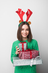 Isolated young smiling girl holds red and green gifts