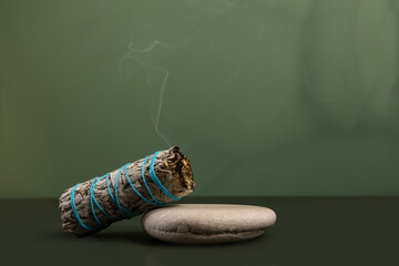 Incense white sage, California dry sage on a green background. Mystical background