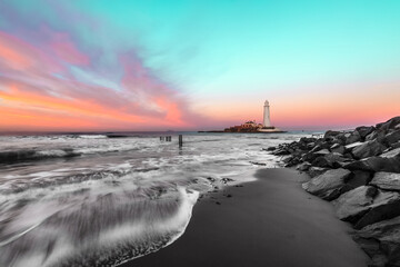 Sunset on the beach at St. Mary's Lighthouse on the Northumberland coastline 