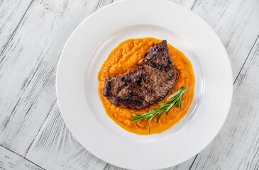 Beef steak with mashed pumpkin