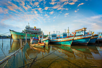 Fototapeta premium Many boats moored in sunrise morning time at Chalong port, Main port for travel ship to krabi and phi phi island, Phuket, Thailand