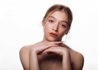 Obraz premium Beauty young woman face. Portrait of cute blonde female with fresh clean skin looking at camera. Isolated on white background. Beautiful, spa and skin care concept.