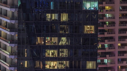 Windows lights in modern office and residential buildings timelapse at night