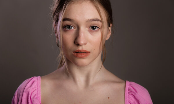 Close up emotional portrait sad or depressed woman. Young woman begging for help and going to cry on dark background