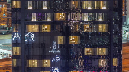 Windows lights in modern towers and residential buildings timelapse at night