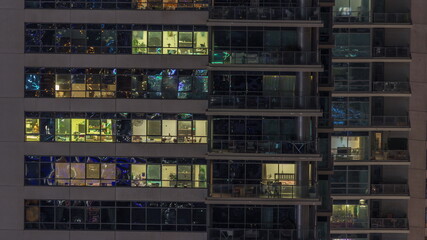 Fototapeta na wymiar Windows lights in modern office and residential buildings timelapse at night
