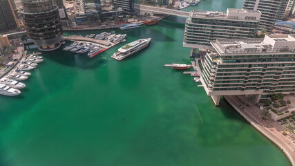 Fototapeta na wymiar Dubai marina promenade on waterfront along canal aerial timelapse.