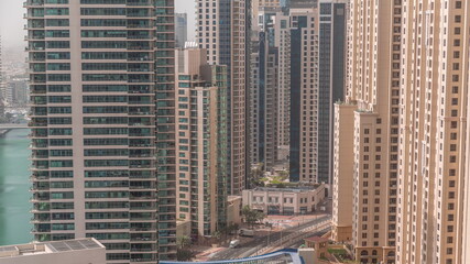 Overview to JBR and Dubai Marina skyline with modern high rise skyscrapers waterfront living apartments aerial timelapse