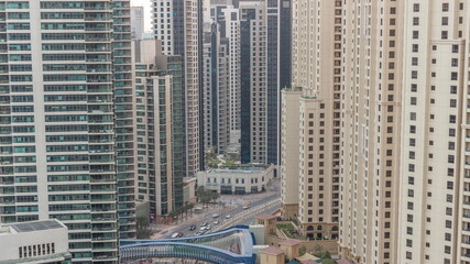 Overview to JBR and Dubai Marina skyline with modern high rise skyscrapers waterfront living apartments aerial day to night timelapse