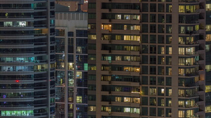 Fototapeta na wymiar Windows lights in modern office and residential buildings timelapse at night