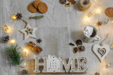 Moscow, Russia, December 2021, New Year and Relative postcard, New Year's composition, Christmas composition, cinnamon, cookies and a garland of lights on a white wood background