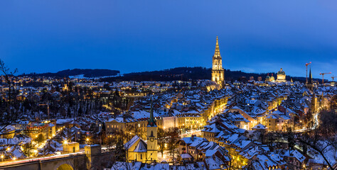 Panorama of the town center of Bern in winter blue hour with snowy and illuminated buildings, Rosengarten, Bern, UNESCO, Switzerland