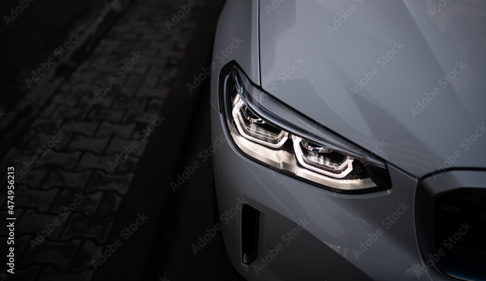 Wall mural Detail close up view of the LED adaptive head light of premium luxury sedan car. Automotive headlight lighting technology detail.