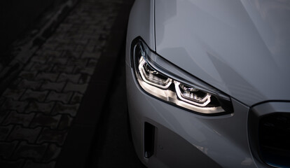 Detail close up view of the LED adaptive head light of premium luxury sedan car. Automotive...