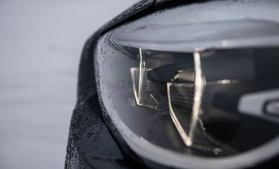 Detail close up view of the LED adaptive head light of premium luxury sedan car. Automotive...