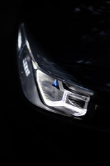 Fototapeta premium Detail close up view of the LED adaptive head light of premium luxury sedan car. Automotive lighting technology detail.