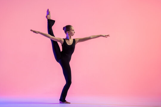Young teenager dancer dancing on a red studio background. Ballet, dance, art, modernity, choreography concept