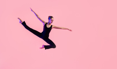 Young teenager dancer dancing on a red studio background. Ballet, dance, art, modernity,...
