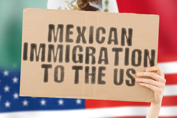 The phrase " Mexican Immigration to the US " on a banner in men's hand with blurred American flag on the background. Visa. National. Secure. Integration. Relationship. Poverty. Policy