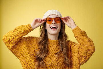 Joyful stylish caucasian girlfriend enjoying sunlight winter ski resort wearing sunglasses hat warm...