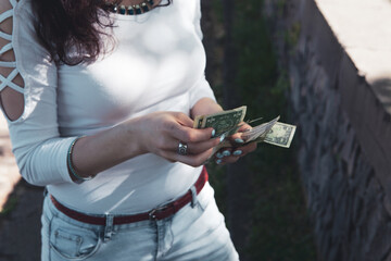 girl counts money in the park