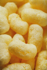 Golden corn sticks in powdered sugar close-up.