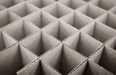 Abstract background. Square cardboard partitions close-up. Partitions for transporting fragile glass items. Sepia toning.
