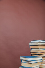 Stacks of books for teaching knowledge university library brown background