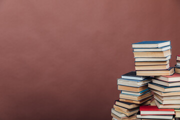 Stacks of books for teaching knowledge university library brown background