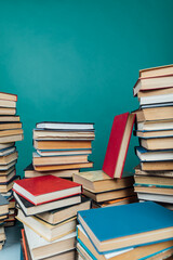 Stacks of books for teaching knowledge college library green background