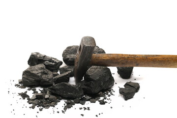 Black coal chunks with hammer isolated on white background