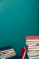 Stacks of books for teaching knowledge college library green background