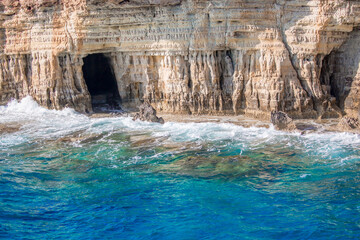 Beautiful scenic rocks in Cyprus caves and grottoes on the shores of the Mediterranean, a background with beautiful rock texture as a concept of travel and tourism travel