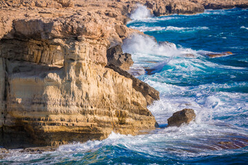 Beautiful scenic rocks in Cyprus caves and grottoes on the shores of the Mediterranean, a background with beautiful rock texture as a concept of travel and tourism travel