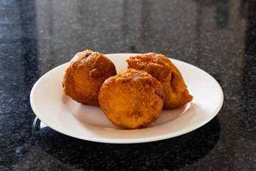 Deep fried homemade fat cakes in a white plate. Amagwinya