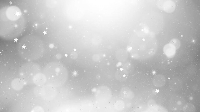 Artistic silver bokeh background with stars and falling silver glitter particles. Copy space holiday celebration seamless loop background animation.