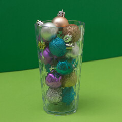 Drink from New Year's decorations on a background of green shades. Minimalistic scene.