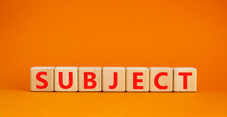 Subject symbol. The concept word Subject on wooden cubes. Beautiful orange table, orange background, copy space. Business and subject concept.