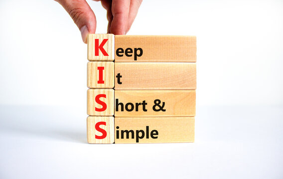 KISS keep it short and simple symbol. Concept words KISS keep it short and  simple wooden blocks. Beautiful white table, white background. Business  KISS keep it short and simple concept. Copy space.