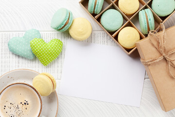 Homemade macaroons in gift box and coffee