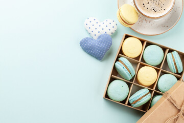 Homemade macaroons in gift box and coffee