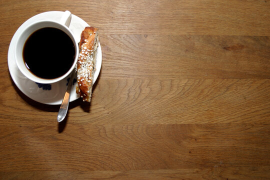 Coffee cup on an oak table.