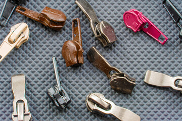 zipper slider. Accessories for repair and tailoring. Background for a repair studio from a variety...