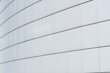 An empty white background of square cells. The walls of the building are covered with square metal panels, the exterior of the buildings, design solutions.