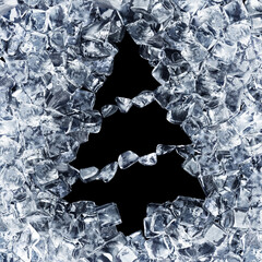 Christmas tree with a garland of ice cubes. A hole in a placer of ice in the form of a fir on a...