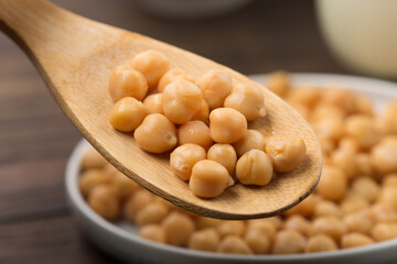 Cooked Chickpeas on dark wooden background. Healthy, nutritious, gluten free and vegetarian food concept.