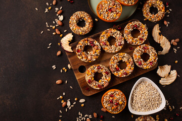 Homemade birdseed dumplings, winter food for birds, dark wooden background, top view.