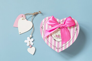 Valentine's day concept with heart gift box on a blue background, minimal layout. Top view flat lay.