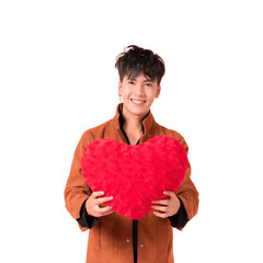 Portrait of happy handsome Asian young man in fashionable clothes standing smiling and holding red heart shape pillow in studio isolated on white background with clipping path.