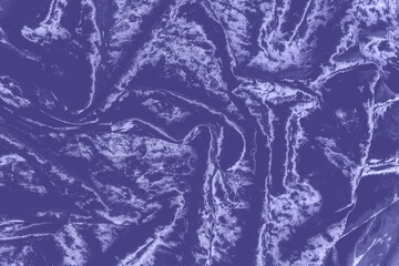 Abstract background on velvet fabric colored of the year 2022 Very Peri. Top view. Texture of velvet purple drapery.
